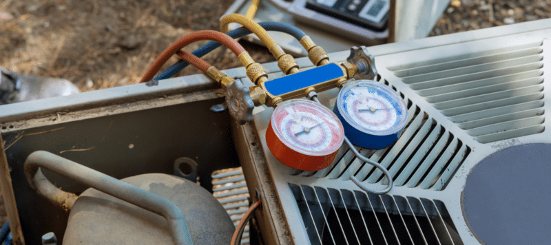 closeup of pressure readers sitting on an outdoor hvac unit