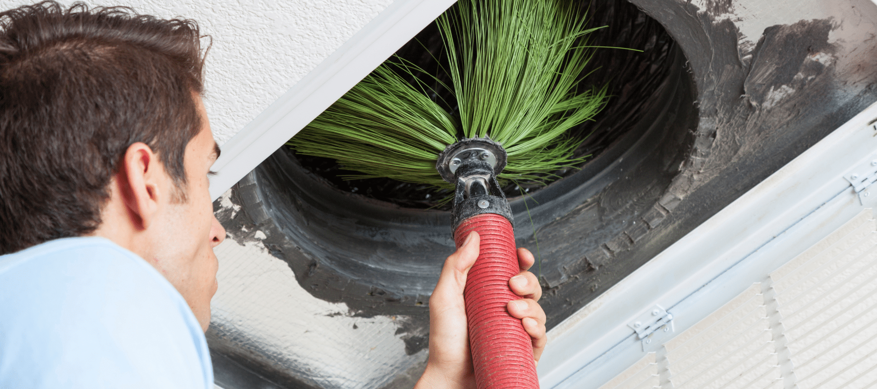 closeup of an hvac technician performing air duct cleaning